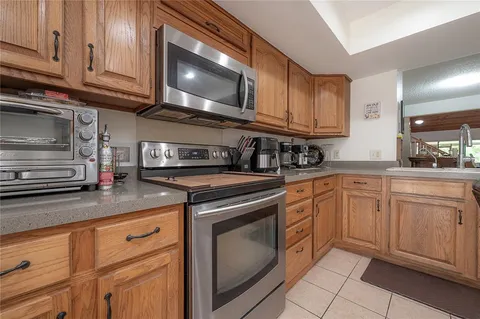 a kitchen with granite countertop cabinets stainless steel appliances and a sink