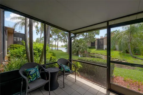 a dining room with furniture and a floor to ceiling window