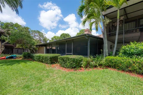 a view of a house with a backyard