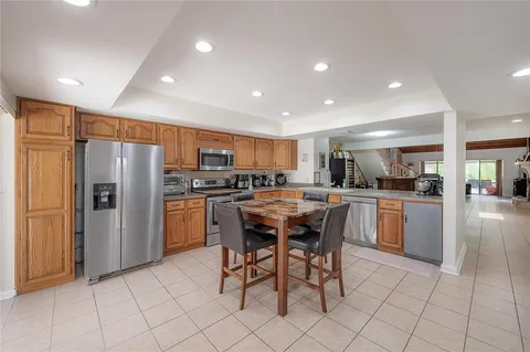 a kitchen with stainless steel appliances granite countertop a refrigerator and a stove top oven