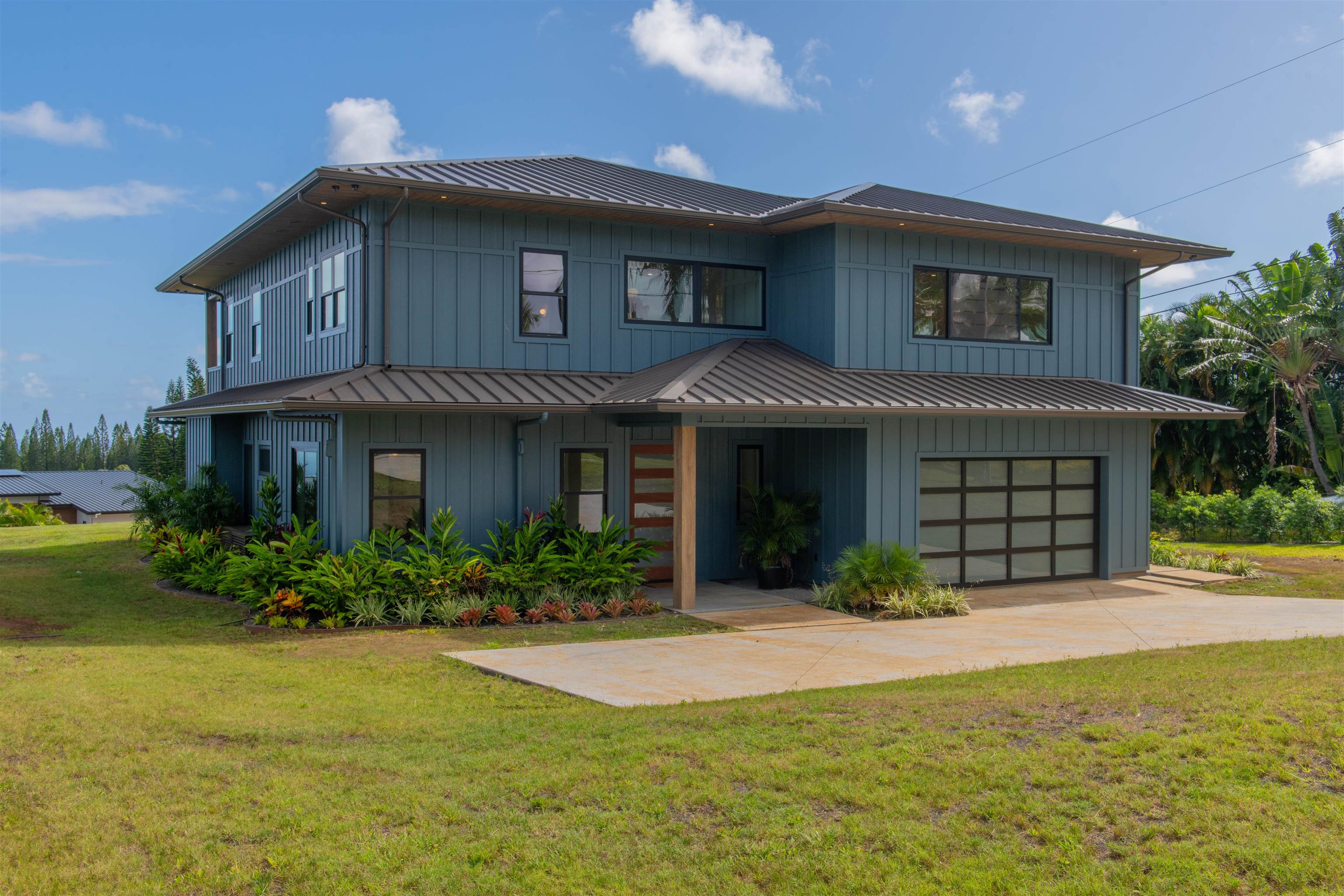 111 Mehana Road, Unit A Haiku, HI 96708 - Photo 5 of 50 a front view of a house with a yard and potted plants