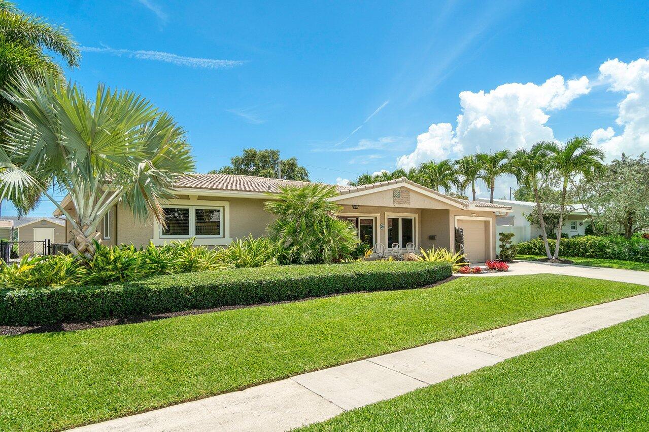 1018 Southwest 14th Street Boca Raton, FL 33486 - Photo 2 of 33 a front view of a house with a garden