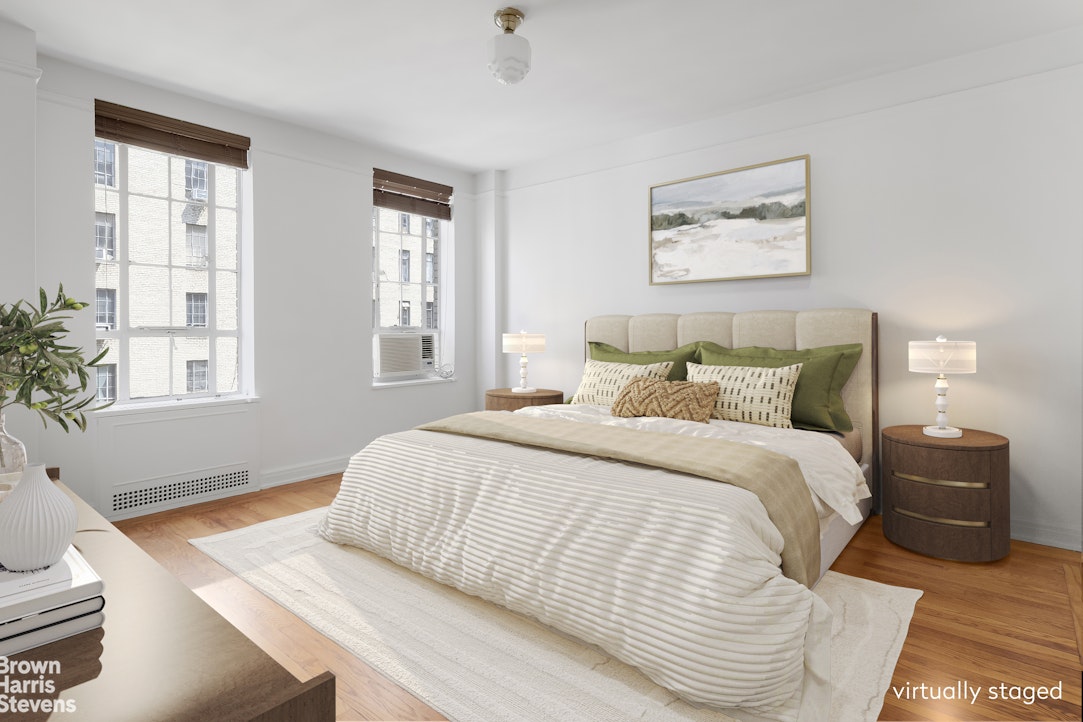 353 West 56th Street, Unit 9F Manhattan, NY 10019 - Photo 7 of 10 a bedroom with a bed and wooden floor