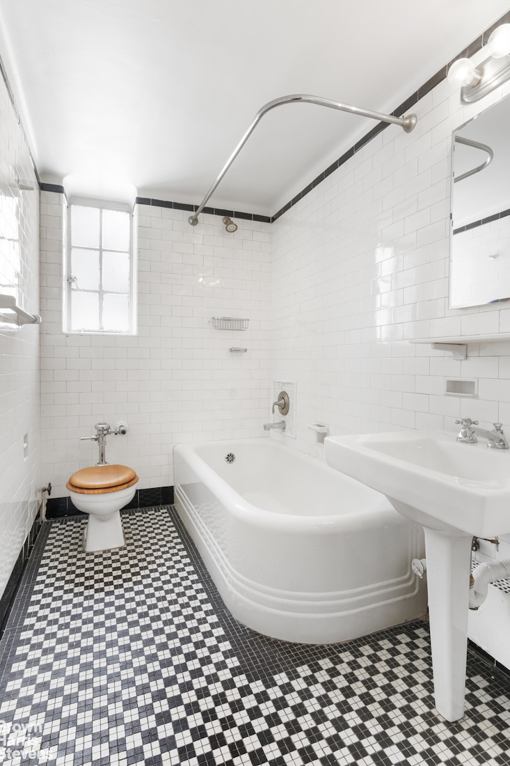 353 West 56th Street, Unit 9F Manhattan, NY 10019 - Photo 9 of 10 a bathroom with a sink and a mirror