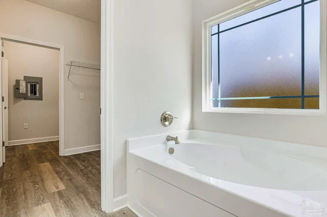 a white bath tub sitting next to a window