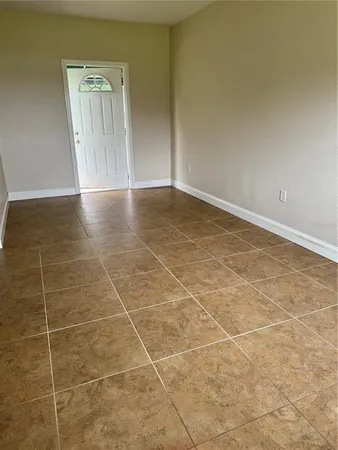 a view of a room with wooden floor and white walls