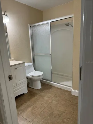 a bathroom with a toilet and a shower