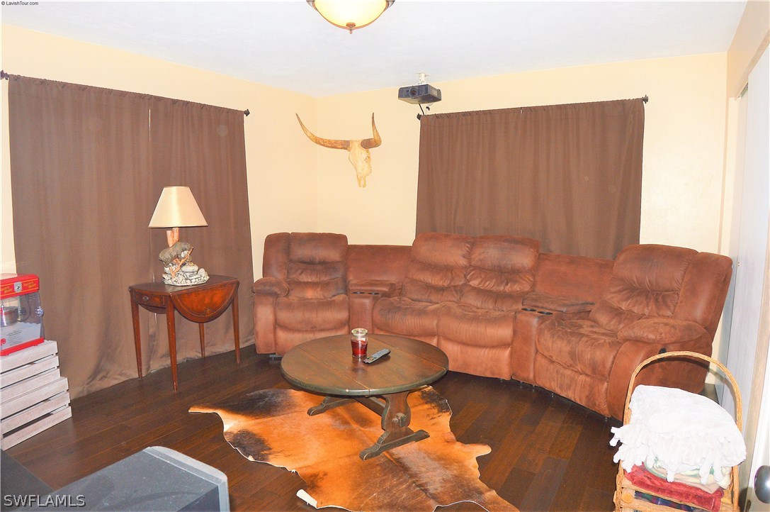 19661 North River Road Alva, FL 33920 - Photo 15 of 25 a living room with furniture and a chandelier