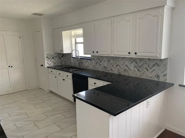 a kitchen with a sink and cabinets