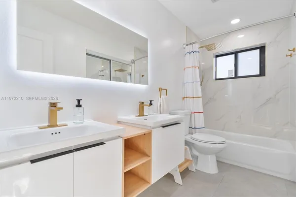 a spacious bedroom with two beds and painted walls