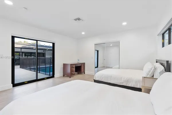 a view of a house with a yard and tree