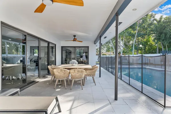 an aerial view of a houses with a yard and lake view