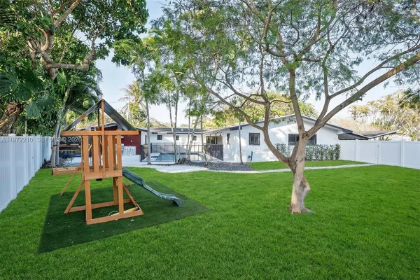 a view of a terrace with chairs and iron fence