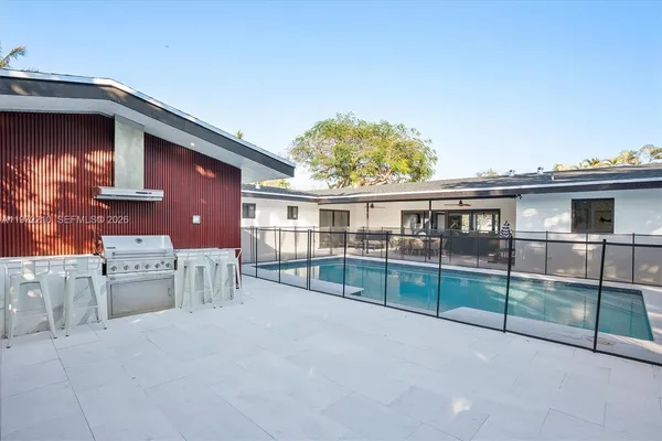 a front view of a house with a yard table and chairs