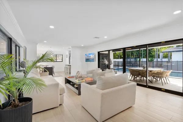 a living room with furniture and large windows