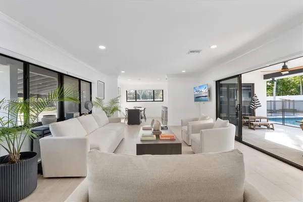 a living room with fireplace furniture and a large window