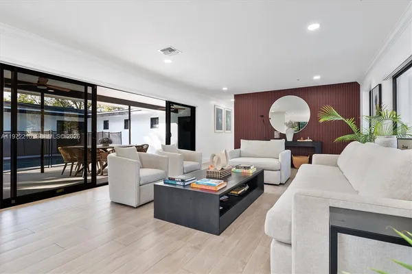 a living room with furniture and wooden floor