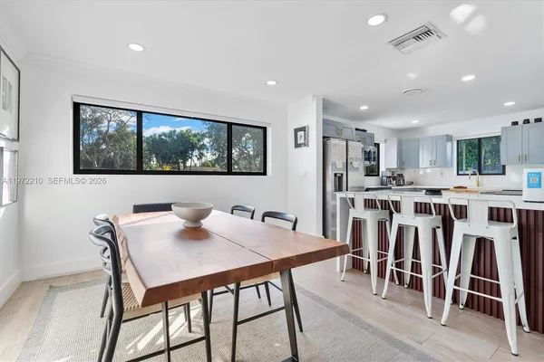 a view of a dining room with furniture and wooden floor