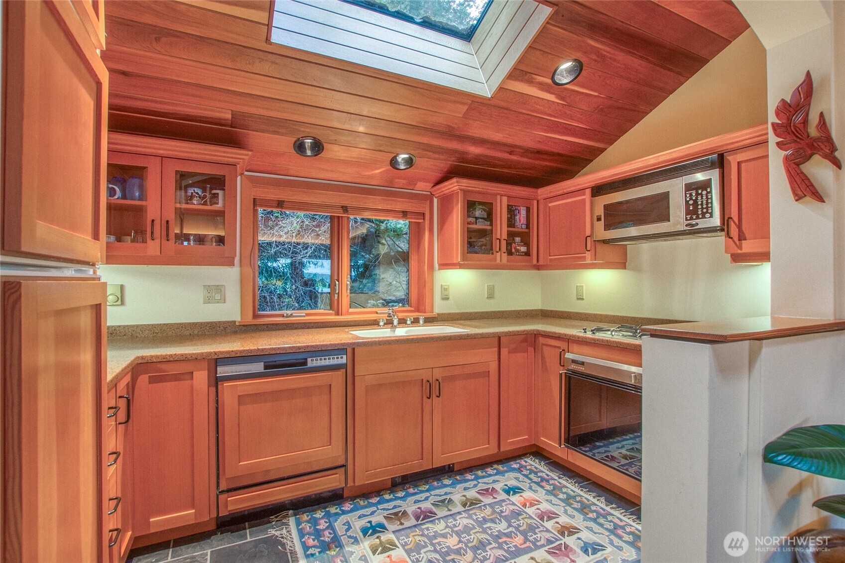1689 Spring Point Road Orcas Island, WA 98245 - Photo 32 of 40 a kitchen with stainless steel appliances granite countertop a sink and cabinets