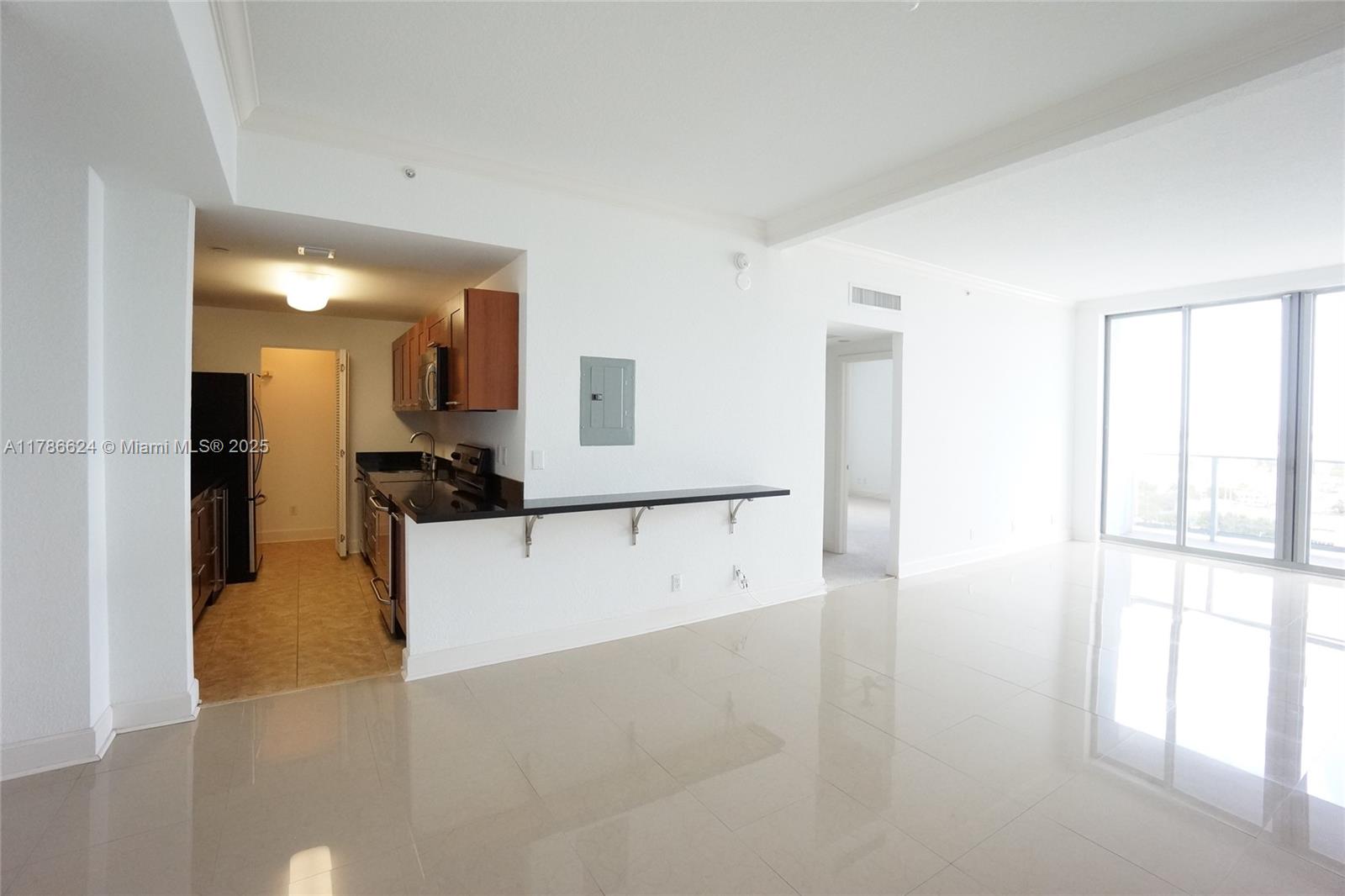 401 69th Street, Unit PH101 Miami Beach, FL 33141 - Photo 10 of 25 a view of a living room with a large window