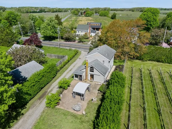 an aerial view of a house with a yard