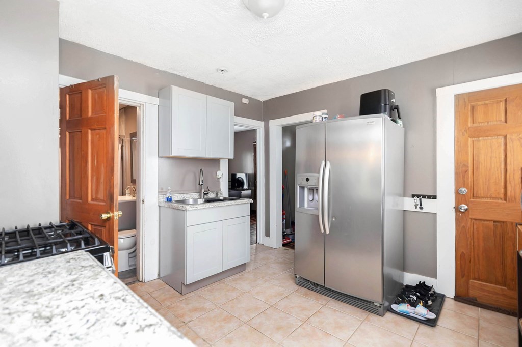 77 Grover Street Springfield, MA 01104 - Photo 8 of 31 a kitchen with stainless steel appliances a refrigerator and a stove