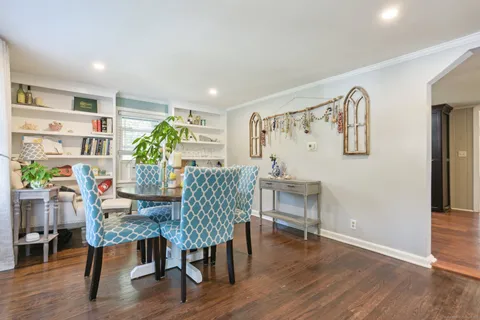 a dining room with furniture and wooden floor