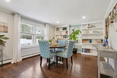 a view of a dining room with furniture window and wooden floor
