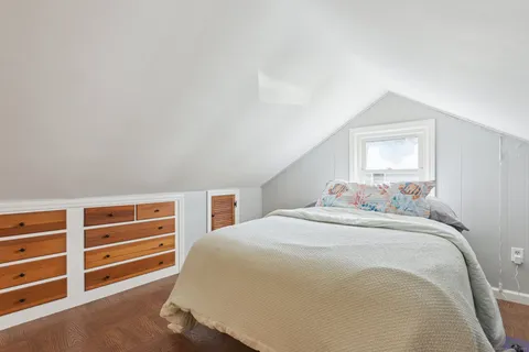 a bedroom with a bed and a dresser