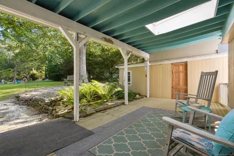 a view of a house with yard and sitting area