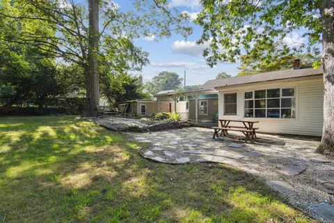 a view of a table and chairs in the garden