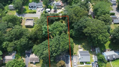 a picture of a room with a white wall and a painting