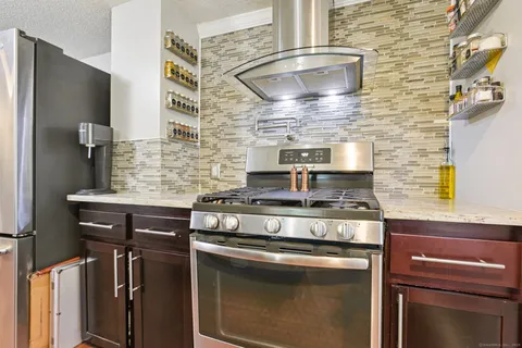 a stove top oven sitting inside of a kitchen