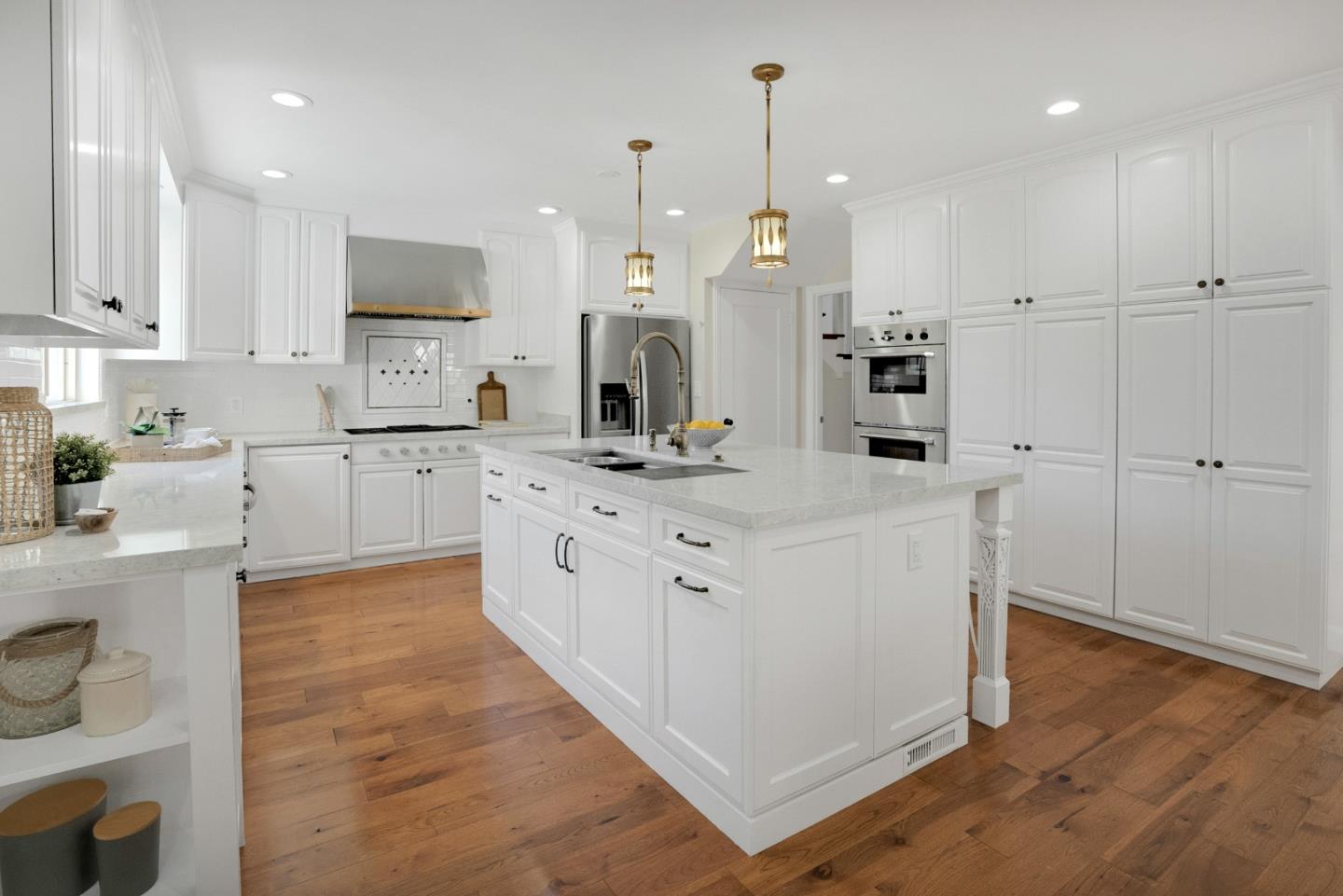 731 Hillcrest Boulevard Millbrae, CA 94030 - Photo 12 of 48 a large white kitchen with kitchen island a sink a stove and a refrigerator