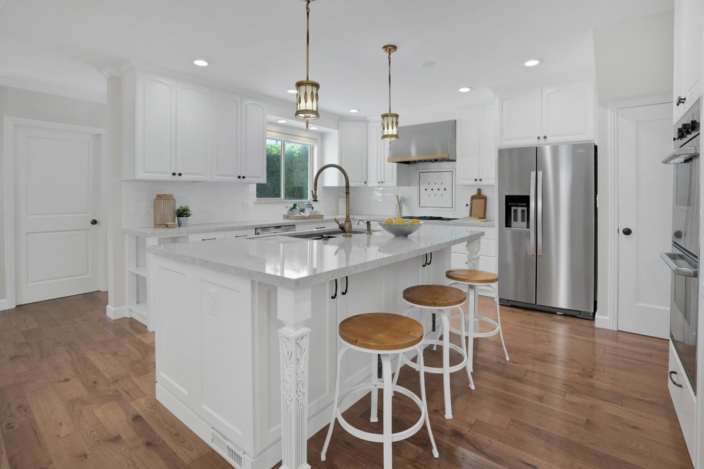 731 Hillcrest Boulevard Millbrae, CA 94030 - Photo 14 of 48 a kitchen with stainless steel appliances granite countertop a kitchen island a stove a table and chairs in it