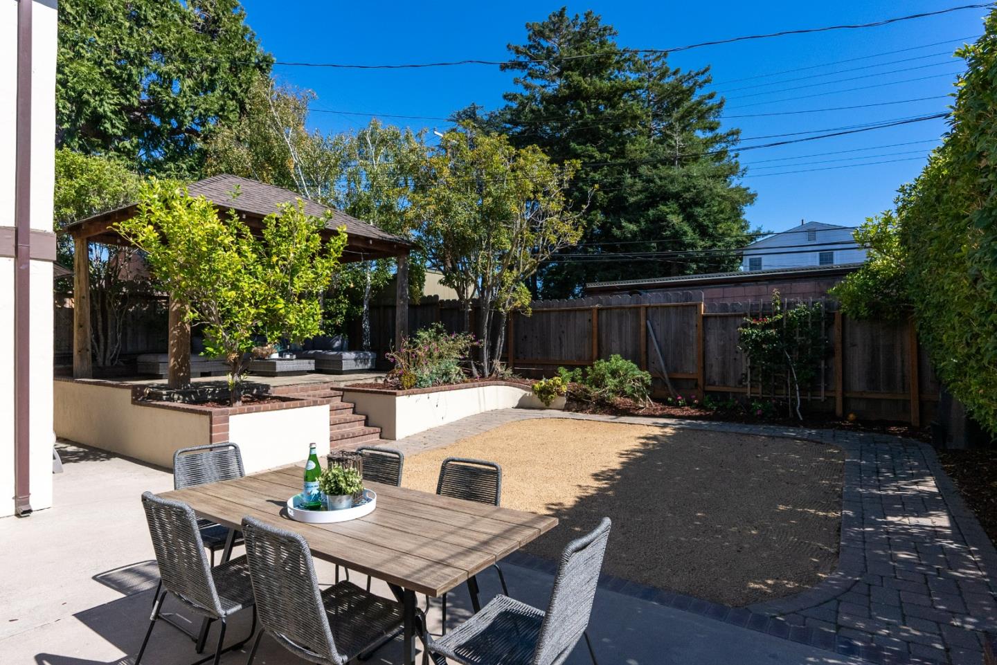 731 Hillcrest Boulevard Millbrae, CA 94030 - Photo 35 of 48 a view of a patio with table and chairs and wooden fence