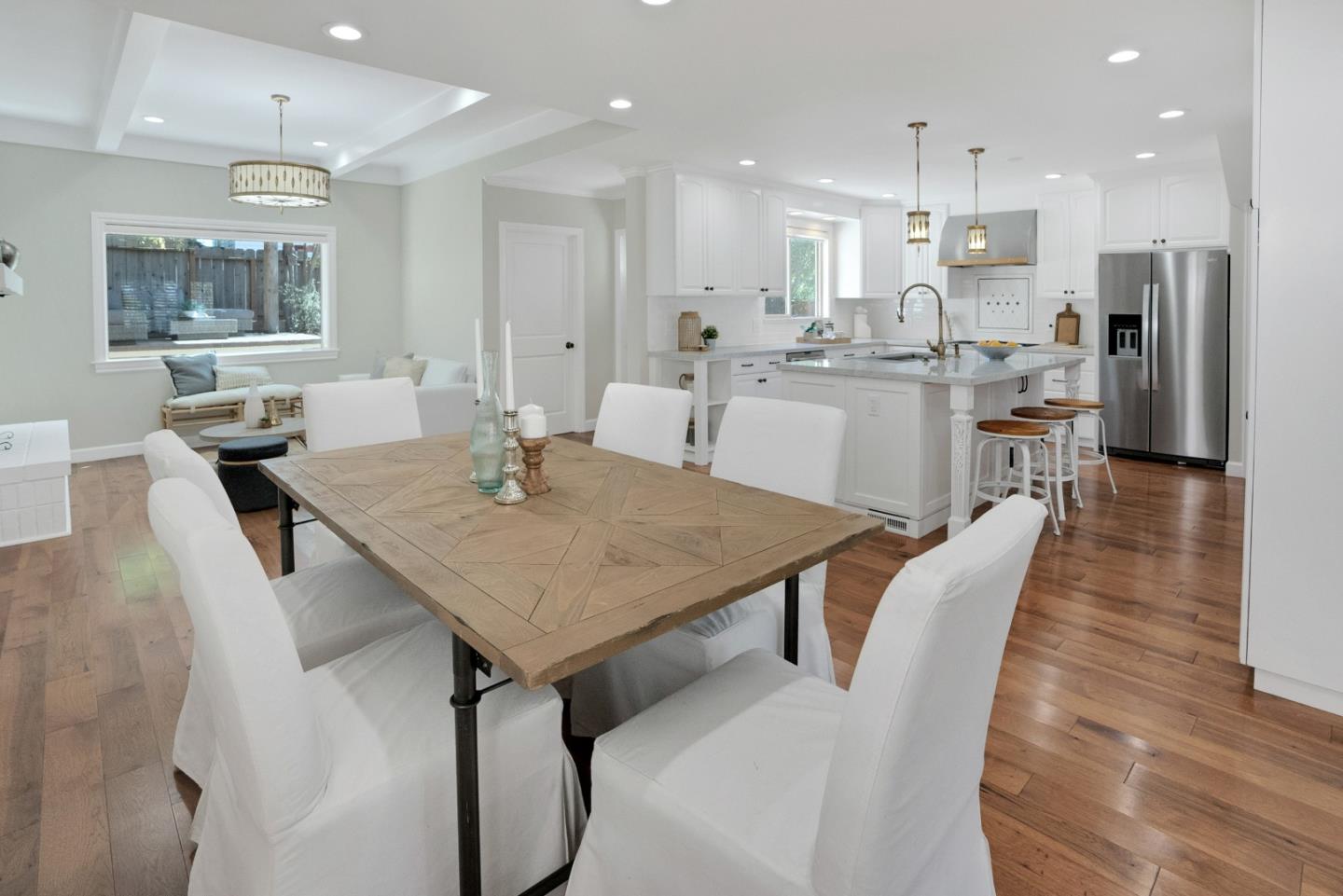 731 Hillcrest Boulevard Millbrae, CA 94030 - Photo 10 of 48 a kitchen with a dining table chairs wooden floor appliances and a counter top space