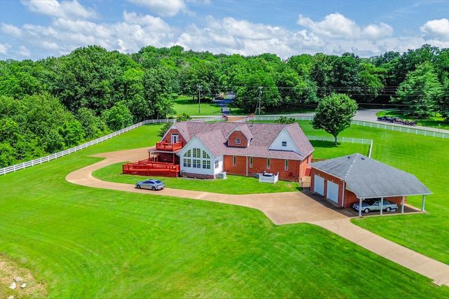 a aerial view of a house with swimming pool and garden