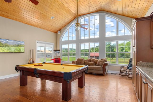 a front view of house with yard and lake view