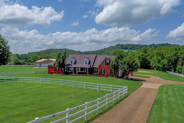 a front view of a house with a yard table and chairs