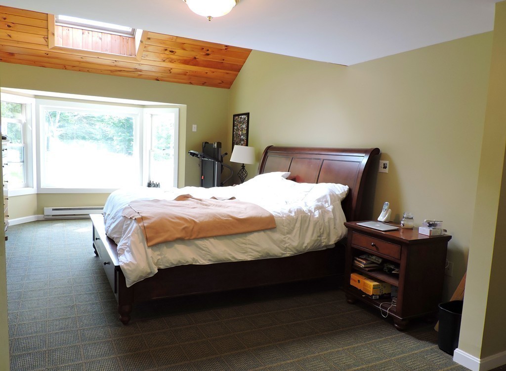 19 Mill Road North Brookfield, MA 01535 - Photo 12 of 30 a bed sitting in a bedroom next to a window