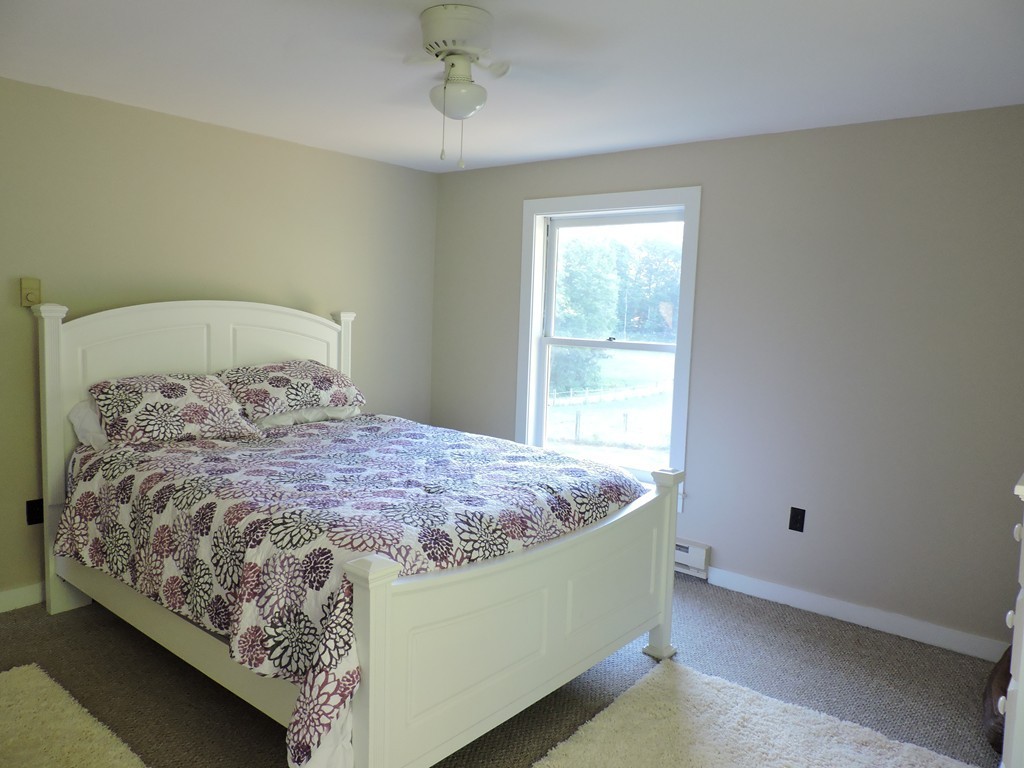19 Mill Road North Brookfield, MA 01535 - Photo 15 of 30 a bed sitting in a bedroom next to a window