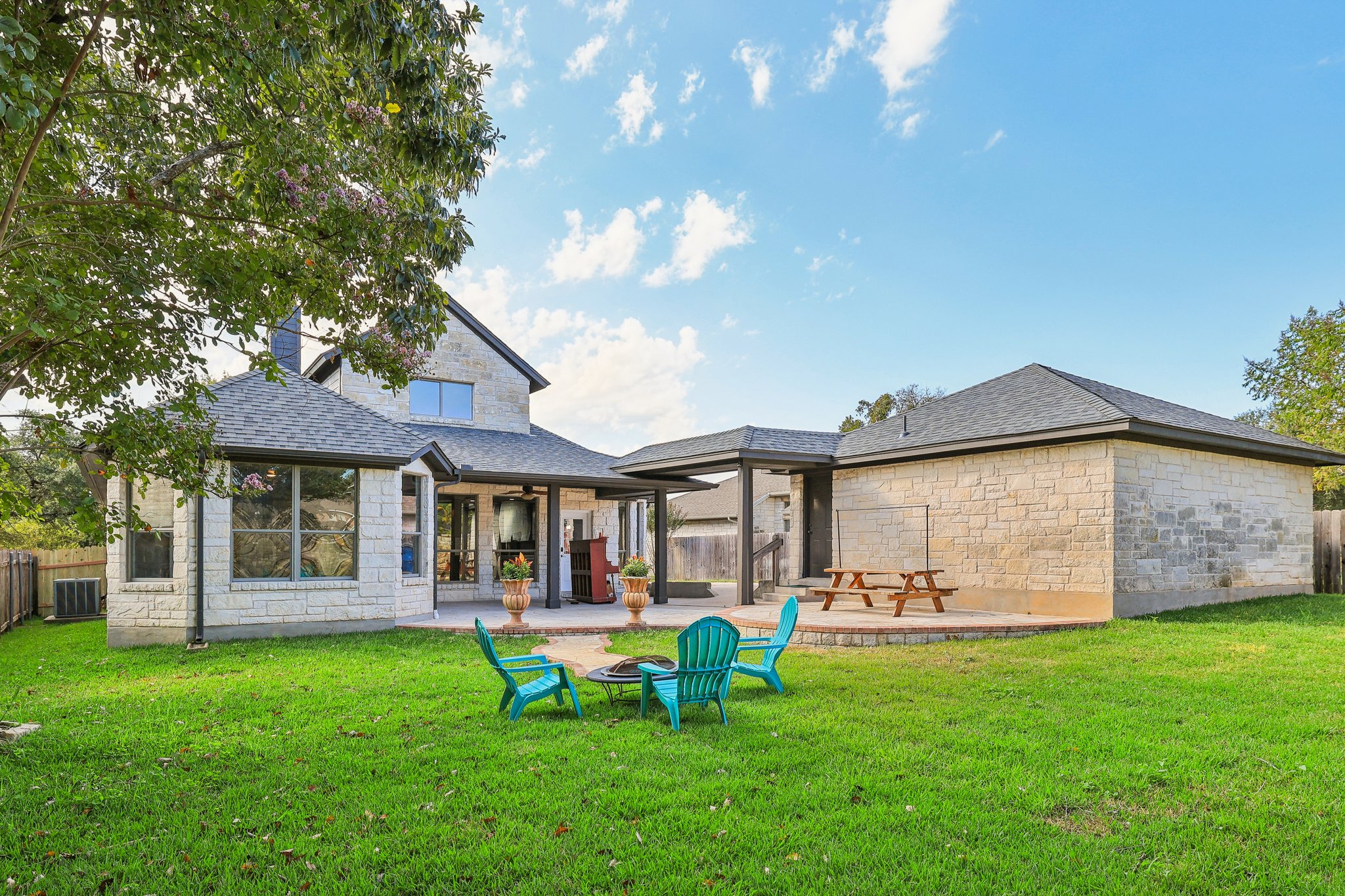 7324 Moon Rock Road Austin, TX 78739 - Photo 27 of 30 a backyard of a house with table and chairs