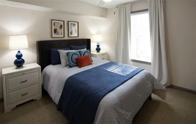 a bedroom with a bed and a window