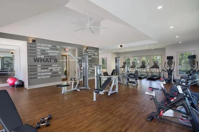 a view of a room with gym equipment and floor to ceiling window
