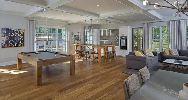 a living room with furniture wooden floor and a table