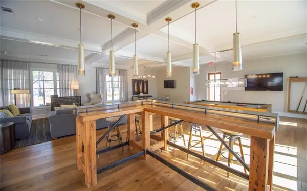 a large kitchen with kitchen island granite countertop a large window a sink and stainless steel appliances