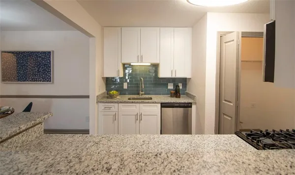 a kitchen with a refrigerator sink and stove