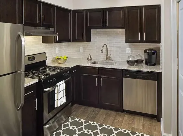 a kitchen with sink cabinets and stainless steel appliances