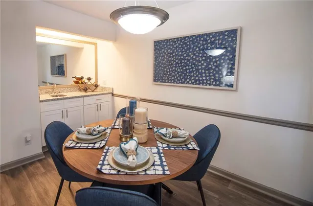 a dining room with furniture and wooden floor